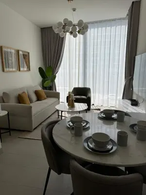 a living room with a table and a couch at Luxury apartment in Sobha Hartland Waves near Dubai mall and Burj Khalifa in Dubai