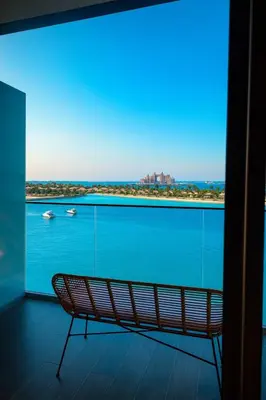 a bench on a balcony with a view of the water at Pure Voyage Beachfront in Dubai