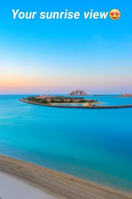 an island in the ocean with a resort in the background at Pure Voyage Beachfront in Dubai