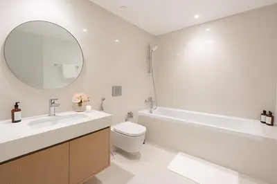 a bathroom with a sink and a toilet and a mirror at Pure Voyage Beachfront in Dubai