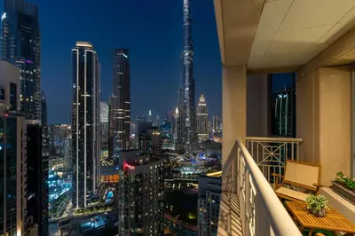 a view of a city skyline at night at Luxury High Floor 1BR with Full Burj Khalifa View by Auberge in Dubai