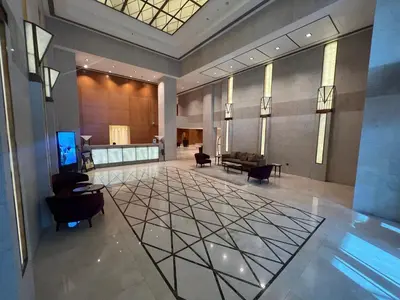 a lobby with chairs and a table in a building at Luxury High Floor 1BR with Full Burj Khalifa View by Auberge in Dubai
