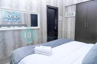 a bedroom with a bed with towels on it at Bloomfields Cozy 1br In Silicon Oasis in Dubai