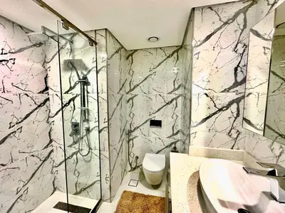 a bathroom with a shower and a toilet and a sink at Prime Location , Bright Studio , High Floor in Dubai