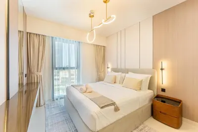 a bedroom with a large bed and a large window at 2 Br in in Burj Crown by Pk Holidays in Dubai