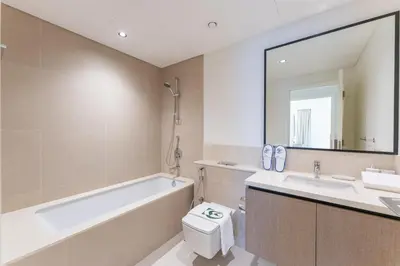 a bathroom with a tub and a toilet and a sink at 2 Br in in Burj Crown by Pk Holidays in Dubai