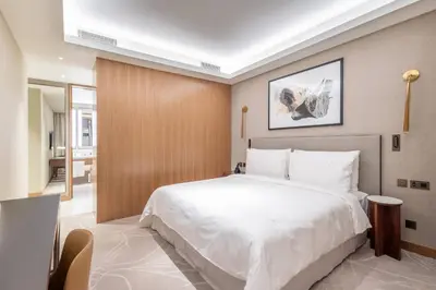 a bedroom with a large white bed in a room at Luxury 2BR at Address Opera Downtown City View in Dubai