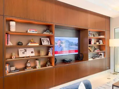 a living room with a tv on a wall at Luxury 2BR at Address Opera Downtown City View in Dubai