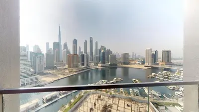 a view of a city with a river and buildings at Burj Khalifa & Lagoon View , Private 1 Bedroom in Dubai