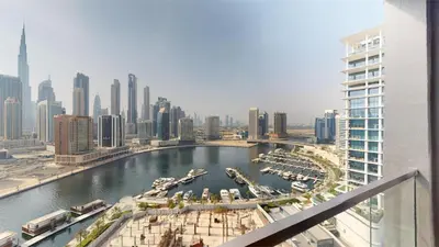 a view of a city with boats in a harbor at Burj Khalifa & Lagoon View , Private 1 Bedroom in Dubai