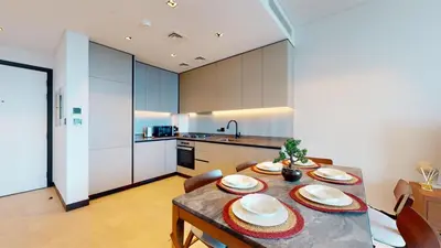 a kitchen with a table with plates on it at Burj Khalifa & Lagoon View , Private 1 Bedroom in Dubai