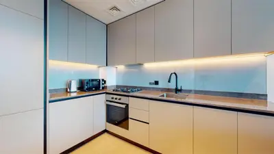 a kitchen with white cabinets and a sink at Burj Khalifa & Lagoon View , Private 1 Bedroom in Dubai