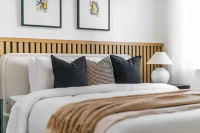 a bedroom with a large white bed with black pillows at Silkhaus Chic 3BDR & maid room in Dubai Marina in Dubai