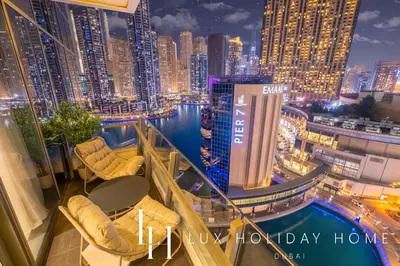 a balcony with a view of a city at night at LUX The Silverene Marina View Suite 4 in Dubai