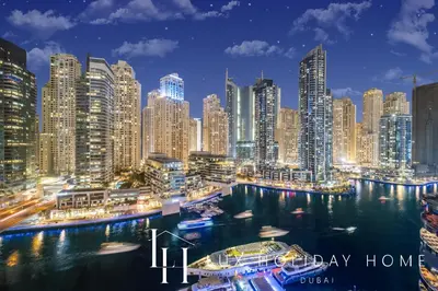 a city skyline at night with boats in the water at LUX The Silverene Marina View Suite 4 in Dubai