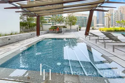 a swimming pool on the roof of a building at LUX The Silverene Marina View Suite 4 in Dubai
