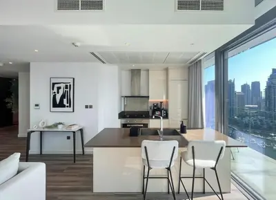 a kitchen with a table and chairs and a large window at Livbnb - 2BR Apartment with Breathtaking Marina View in Dubai