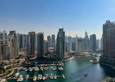 an aerial view of a city with boats in a harbor at Livbnb - 2BR Apartment with Breathtaking Marina View in Dubai