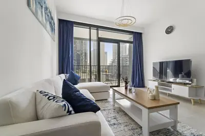 a living room with a couch and a tv at Luxury 1BR apartment at Creek Edge Tower 2 in Dubai