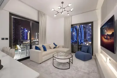 a living room with a couch and a chandelier at Lux Apartment with huge private Lounge I Burj & Canal View in Dubai