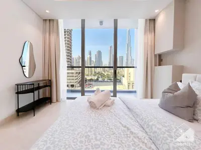 a bedroom with a large white bed with a large window at High End 1Bedroom with Balcony & View Dubai in Dubai