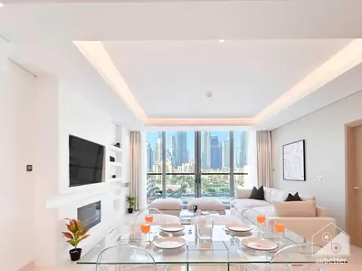a living room with a glass table and a couch at High End 1Bedroom with Balcony & View Dubai in Dubai