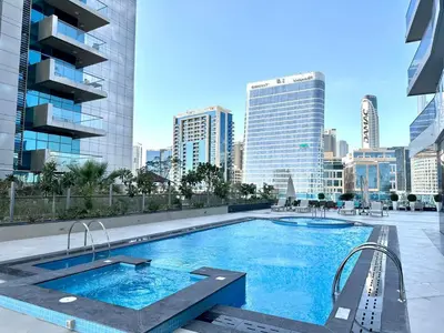 a swimming pool on the roof of a building with a city at Modern Furnished Studio with Canal View , High Floor in Dubai