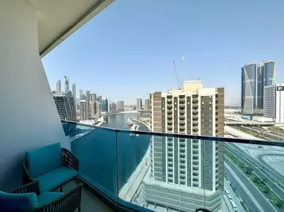 a balcony with a view of a river and buildings at Modern Furnished Studio with Canal View , High Floor in Dubai