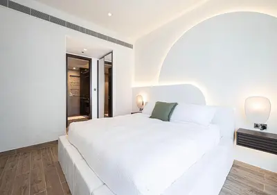 a white bedroom with a white bed and a window at Jumeirah Living Marina Gate - Golf & Skyline Views with Pool & Gym in Dubai