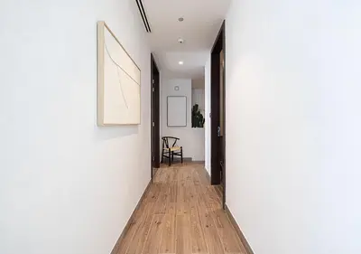 a hallway of a house with white walls and a wooden floor at Jumeirah Living Marina Gate - Golf & Skyline Views with Pool & Gym in Dubai
