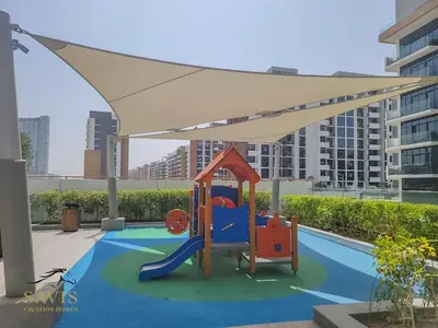 a playground with a canopy on top of a pool at Savis Homes - Azizi Riviera 43 - Chic Studio Near Downtown and Business Bay in Dubai