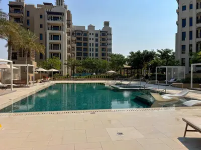 a swimming pool in the middle of a city with buildings at Frank Porter - Lamtara 3 in Dubai