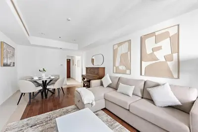 a living room with a couch and a table at Cozy 1-Bedroom Apartment In Princess Tower in Dubai