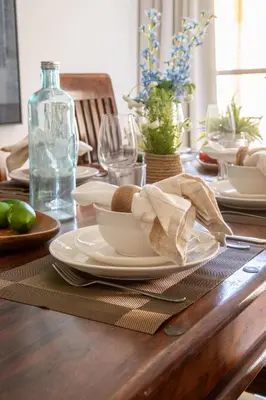 a wooden table with plates and dishes on it at Frank Porter - Shams 4 in Dubai
