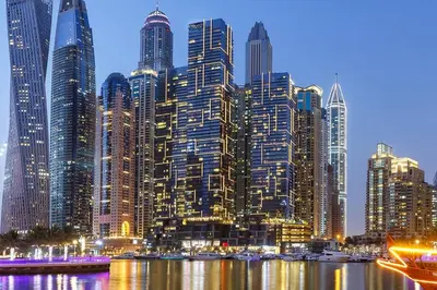 a large city with tall skyscrapers at night at Marina Views in Walkable Location with Pool & Gym in Dubai