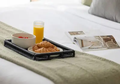 a tray with a bowl of food and a glass of orange juice at Downtown Sky High Luxury Apartment I City And Sea Views I Opp Dubai Mall Burj Khalifa in Dubai