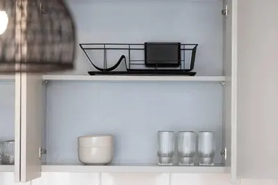 a shelf with a laptop and glasses on it at Downtown Sky High Luxury Apartment I City And Sea Views I Opp Dubai Mall Burj Khalifa in Dubai