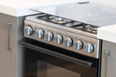 a stove with a bunch of knobs on it in a kitchen at Downtown Sky High Luxury Apartment I City And Sea Views I Opp Dubai Mall Burj Khalifa in Dubai
