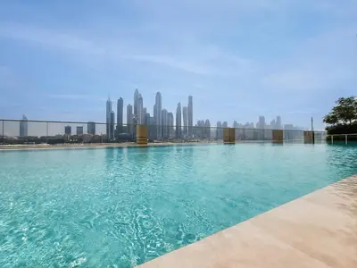 a swimming pool with a city skyline in the background at Stunning 1 bedroom sea view apartment in Dubai