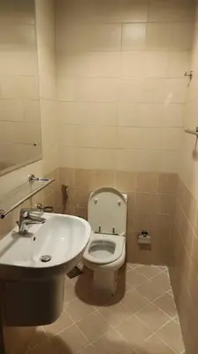 a bathroom with a toilet and a sink at Apartment in Al Barsha1 Near by Metro in Dubai