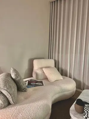 a room with a couch with pillows and a window at Cozy urban stay near Dubai Mall in Dubai