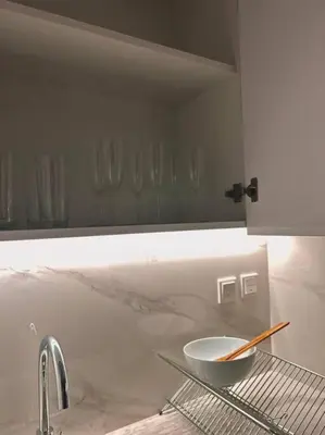 a kitchen with a sink and a bowl on a shelf at Cozy urban stay near Dubai Mall in Dubai