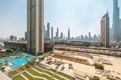 a view of a city with a pool and buildings at Stunning Burj Khalifa Views - Dubai Mall Access - Infinity Pool - MaxStays in Dubai