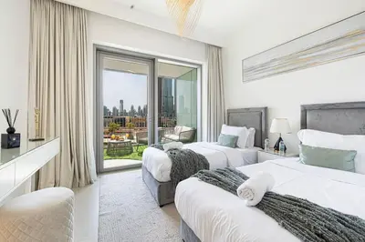 a hotel room with two beds and a large window at Stunning Burj Khalifa Views - Dubai Mall Access - Infinity Pool - MaxStays in Dubai