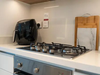 a toaster sitting on top of a stove in a kitchen at Blissful Stays - Luxury Two Bedroom Apartment at Downtown Views II- 5 min walk to Dubai Mall, Burj Khalifa with Infinity Pool in Dubai