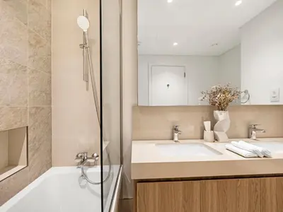 a bathroom with a sink and a shower at Blissful Stays - Luxury Two Bedroom Apartment at Downtown Views II- 5 min walk to Dubai Mall, Burj Khalifa with Infinity Pool in Dubai