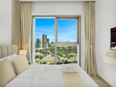 a bedroom with a large white bed and a large window at Blissful Stays - Luxury Two Bedroom Apartment at Downtown Views II- 5 min walk to Dubai Mall, Burj Khalifa with Infinity Pool in Dubai