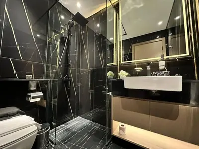 a bathroom with a toilet and a sink and a mirror at Stylish 1br Apartment Jvc Balcony Parking in Dubai