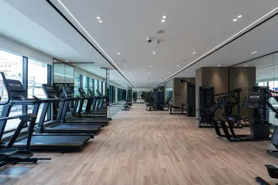 a gym with treadmills and elliptical machines at Stylish 1br Apartment Jvc Balcony Parking in Dubai