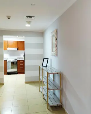 a kitchen with a table in a room at Charming & Comfortable 1BR Jumeirah Bay X1 JLT in Dubai